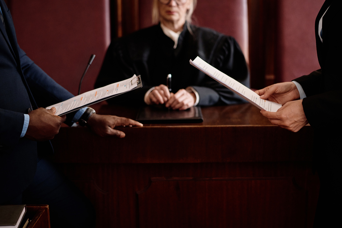 The valuation that survives cross-examination highlights by two people with paper work in front of a judge